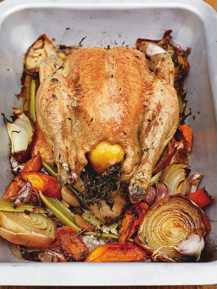 roasted chicken in baking tray with cooked vegetables